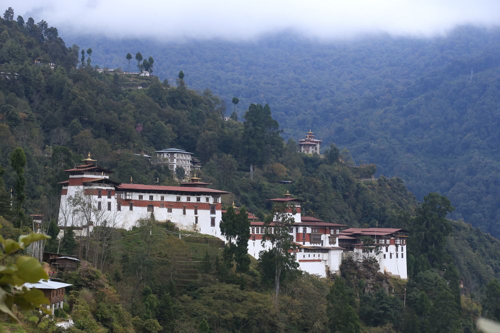 A hillside dzong wrapped in morning mist